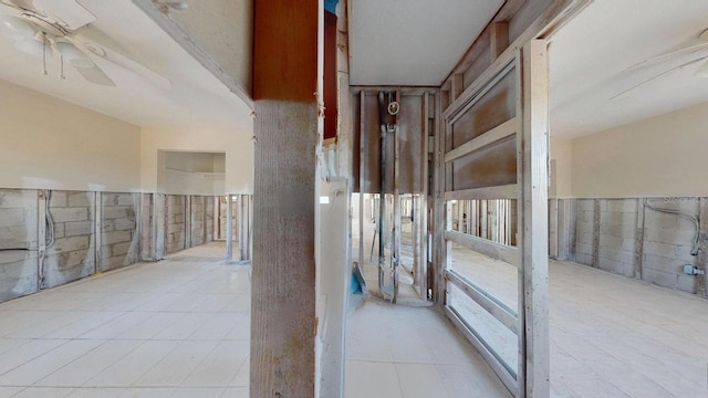 hall featuring light tile patterned flooring