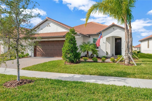 mediterranean / spanish house with a front lawn and a garage