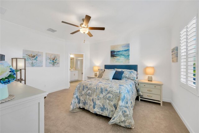 bedroom with light carpet, ceiling fan, connected bathroom, and multiple windows