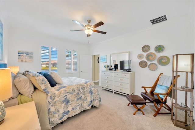 carpeted bedroom with ceiling fan and crown molding