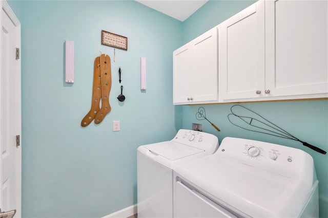 laundry room with washer and clothes dryer and cabinets