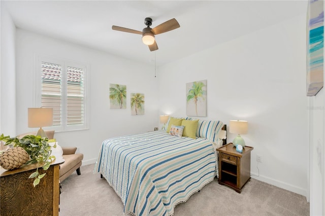 bedroom with ceiling fan and light carpet