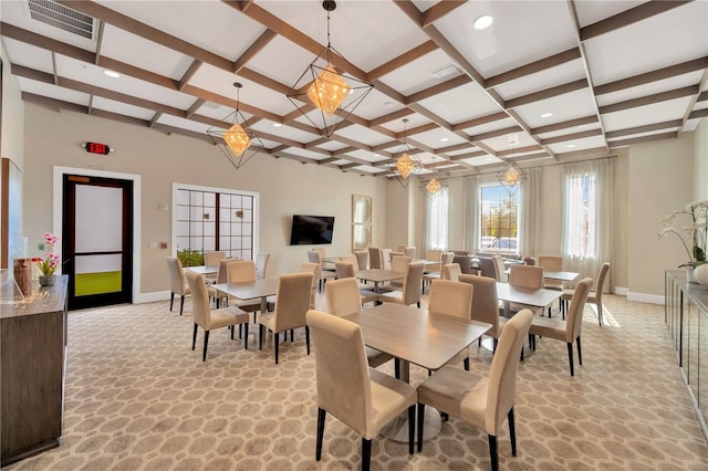 dining room featuring light colored carpet, an inviting chandelier, beamed ceiling, and coffered ceiling