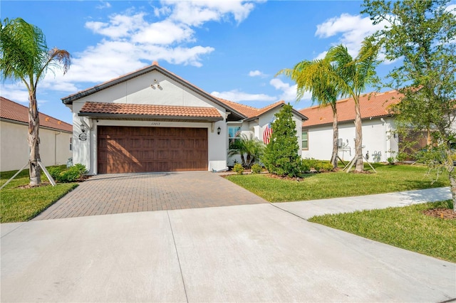 view of front of property with a garage and a front lawn