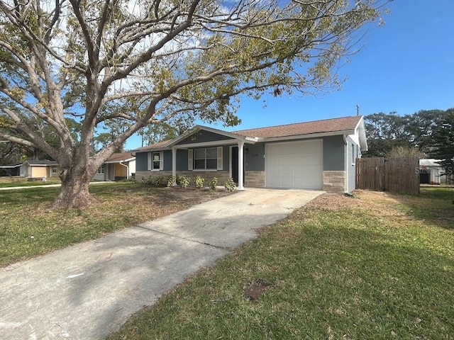 ranch-style house featuring a front yard and a garage