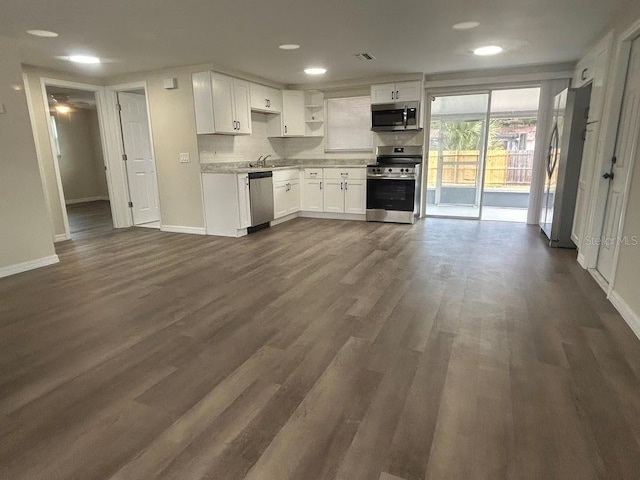 kitchen featuring stainless steel appliances, decorative backsplash, dark hardwood / wood-style flooring, white cabinets, and sink