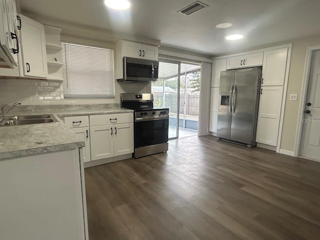 kitchen with sink, white cabinetry, dark hardwood / wood-style floors, and appliances with stainless steel finishes