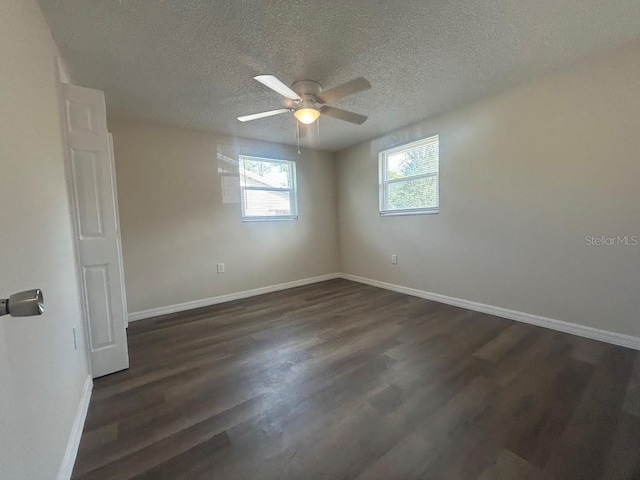 spare room featuring ceiling fan, a textured ceiling, and dark hardwood / wood-style floors