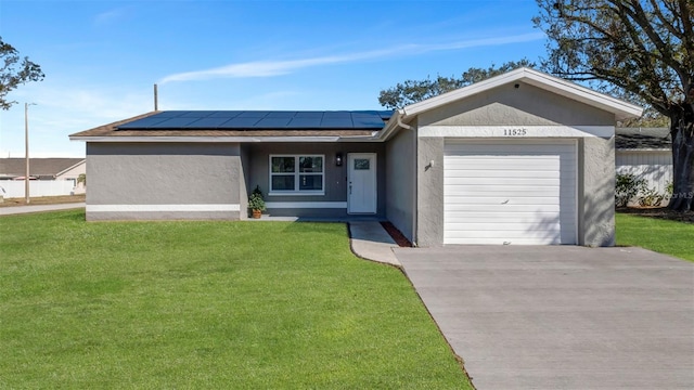 ranch-style home with a front yard, a garage, and solar panels