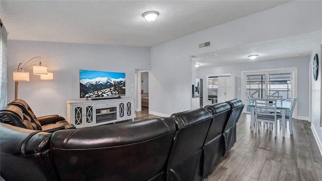 living room with hardwood / wood-style flooring and a textured ceiling