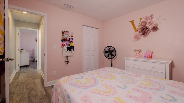 bedroom featuring wood-type flooring and a closet