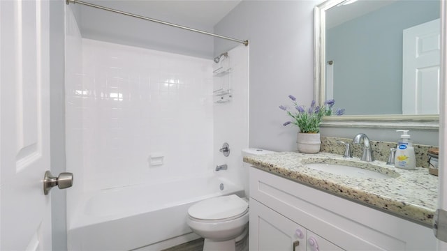 full bathroom featuring tub / shower combination, vanity, and toilet