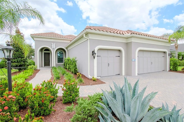 mediterranean / spanish home featuring a garage