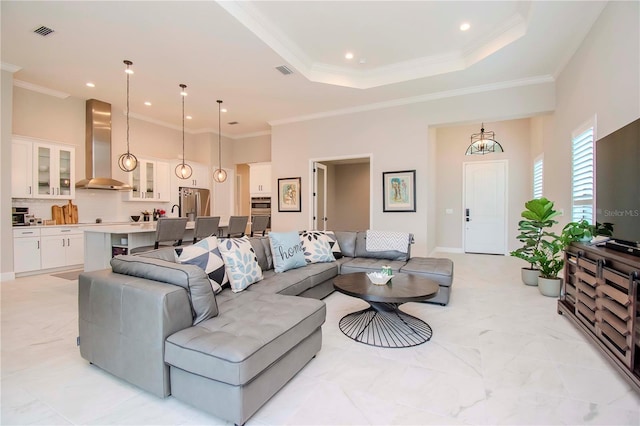 living room featuring ornamental molding and a raised ceiling