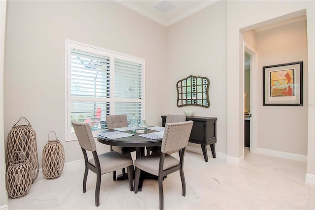 dining space featuring crown molding