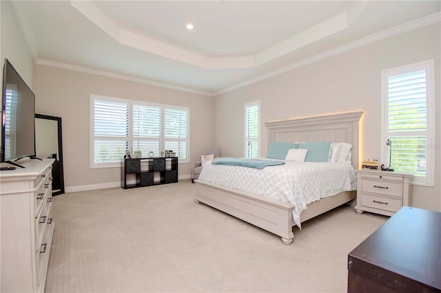 carpeted bedroom featuring multiple windows, a tray ceiling, and crown molding