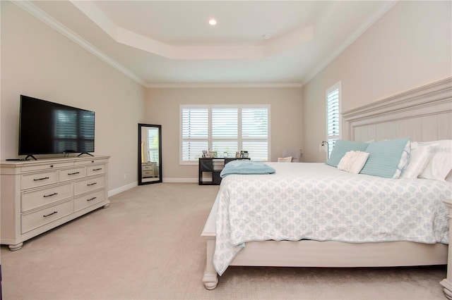 carpeted bedroom featuring crown molding and a raised ceiling