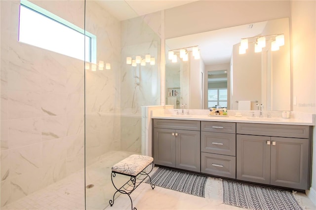 bathroom with vanity and a tile shower