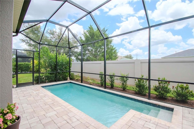 view of pool with a lanai and a patio