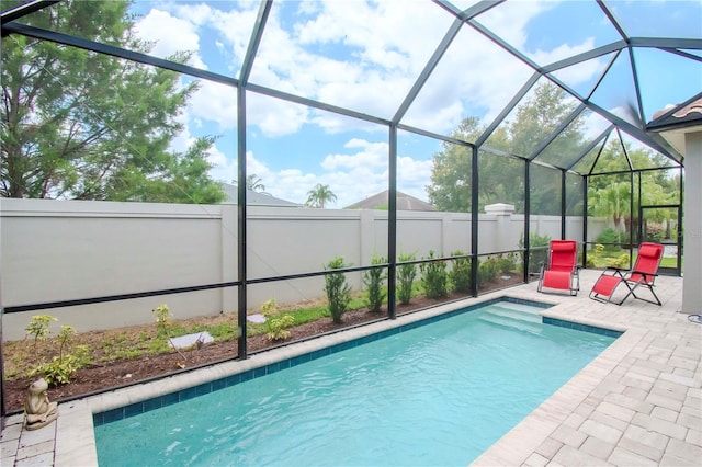 view of pool featuring a lanai and a patio