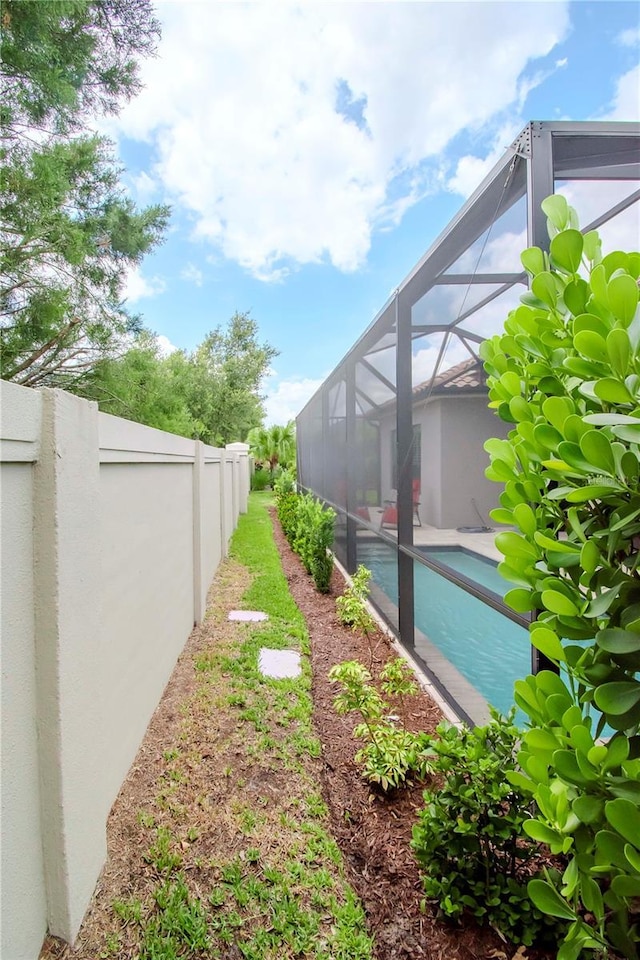 view of yard featuring glass enclosure