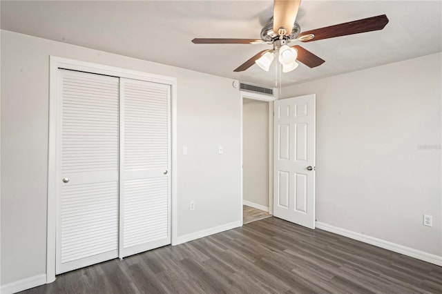 unfurnished bedroom featuring ceiling fan, dark hardwood / wood-style flooring, and a closet