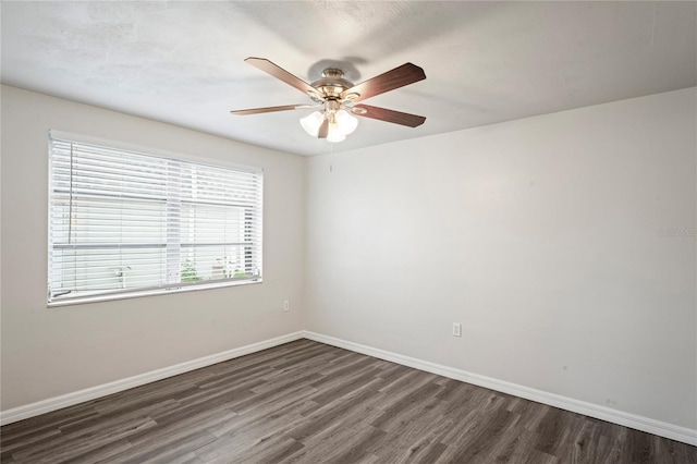 spare room featuring ceiling fan and dark hardwood / wood-style flooring