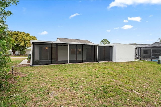 back of house with a sunroom and a yard