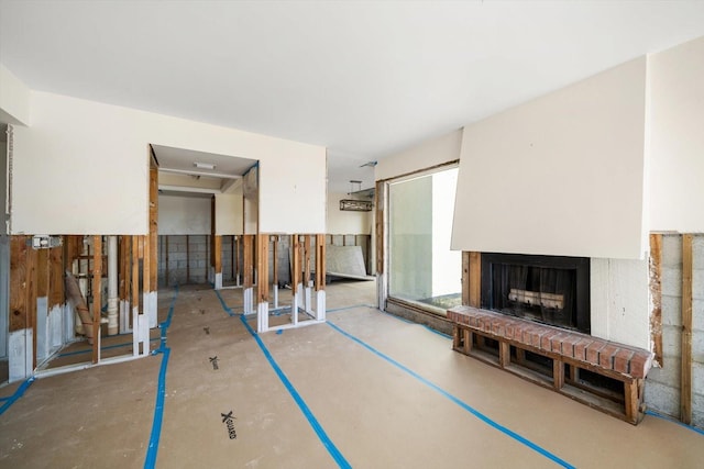 unfurnished living room featuring a brick fireplace