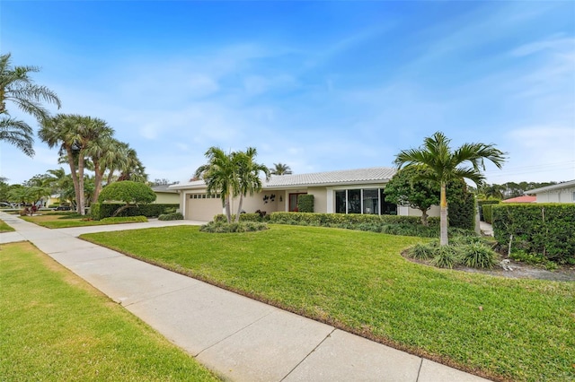 ranch-style home featuring a front yard and a garage