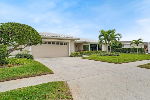 view of front of property with a front yard and a garage