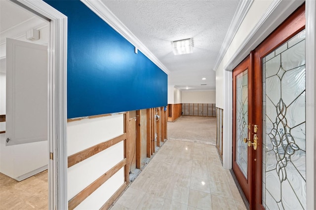 corridor with a textured ceiling and crown molding