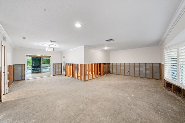 empty room with a textured ceiling and crown molding