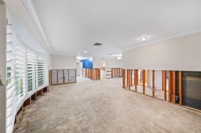 spare room featuring ornamental molding and carpet