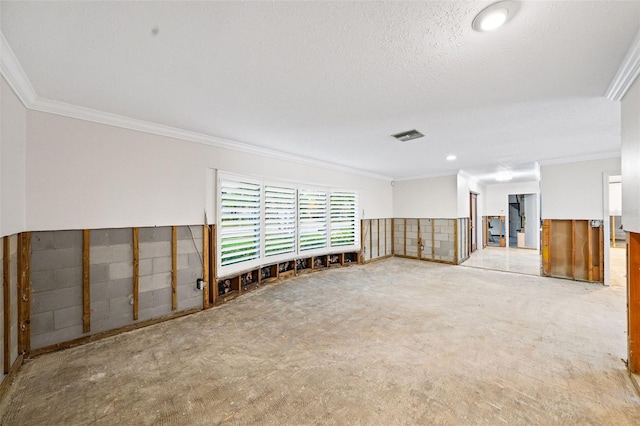 unfurnished room featuring a textured ceiling and ornamental molding