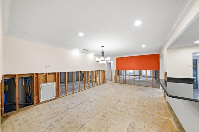 empty room featuring a chandelier and ornamental molding