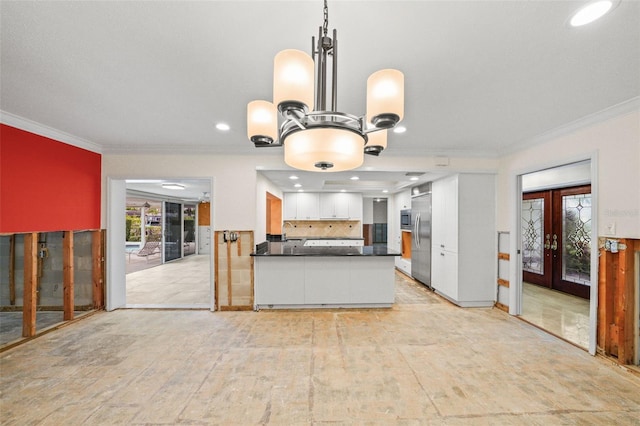 kitchen featuring kitchen peninsula, french doors, crown molding, white cabinetry, and appliances with stainless steel finishes