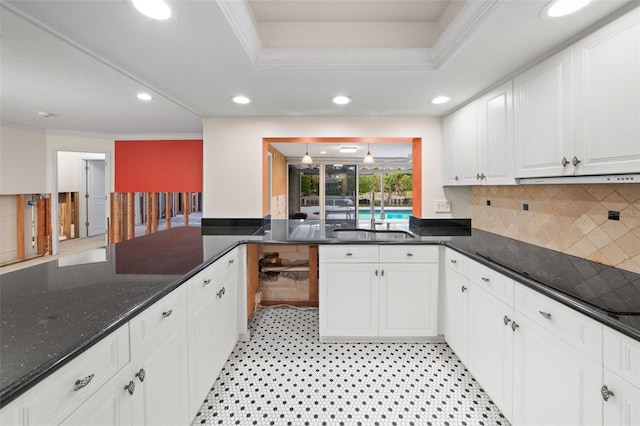 kitchen with white cabinets, ornamental molding, decorative backsplash, and sink