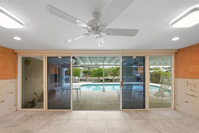 view of swimming pool with ceiling fan