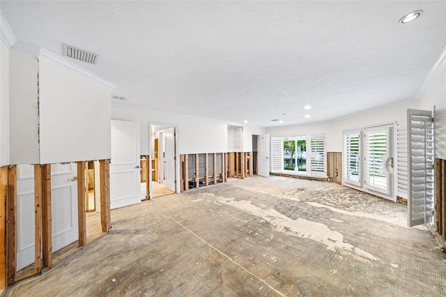 unfurnished living room featuring crown molding