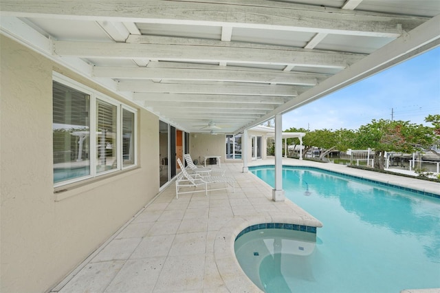 view of pool with ceiling fan and a patio