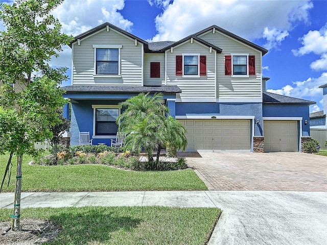 view of front facade featuring a garage and a front yard