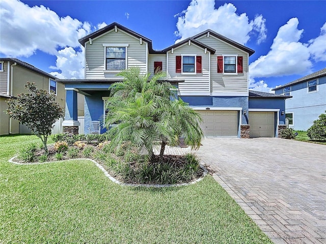 view of front of house with a garage and a front yard