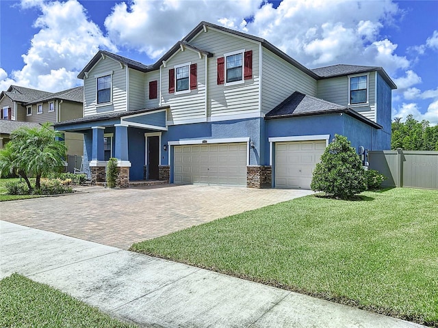 view of front of property with a garage and a front yard