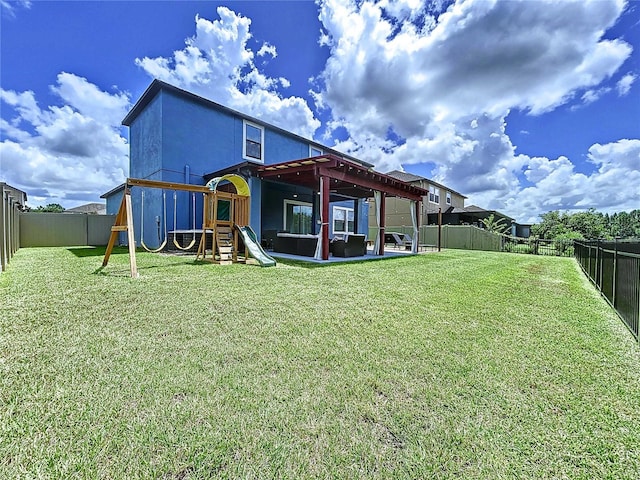 rear view of property with a playground and a yard