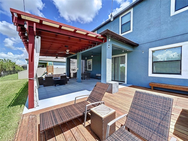 deck with ceiling fan and a pergola