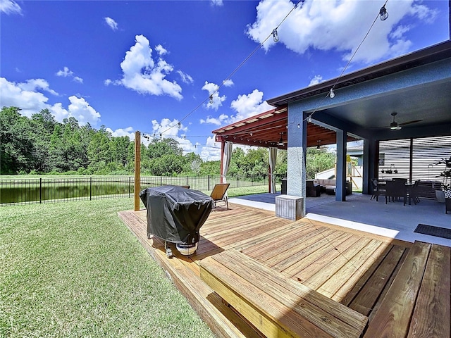 wooden deck with a lawn, ceiling fan, area for grilling, and a patio