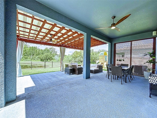 view of patio with a playground, outdoor lounge area, and ceiling fan