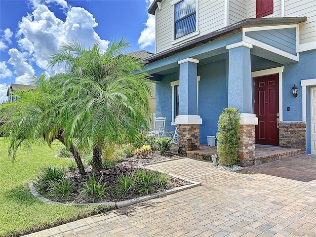 view of exterior entry with a porch