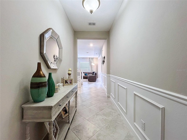 corridor with light tile patterned floors